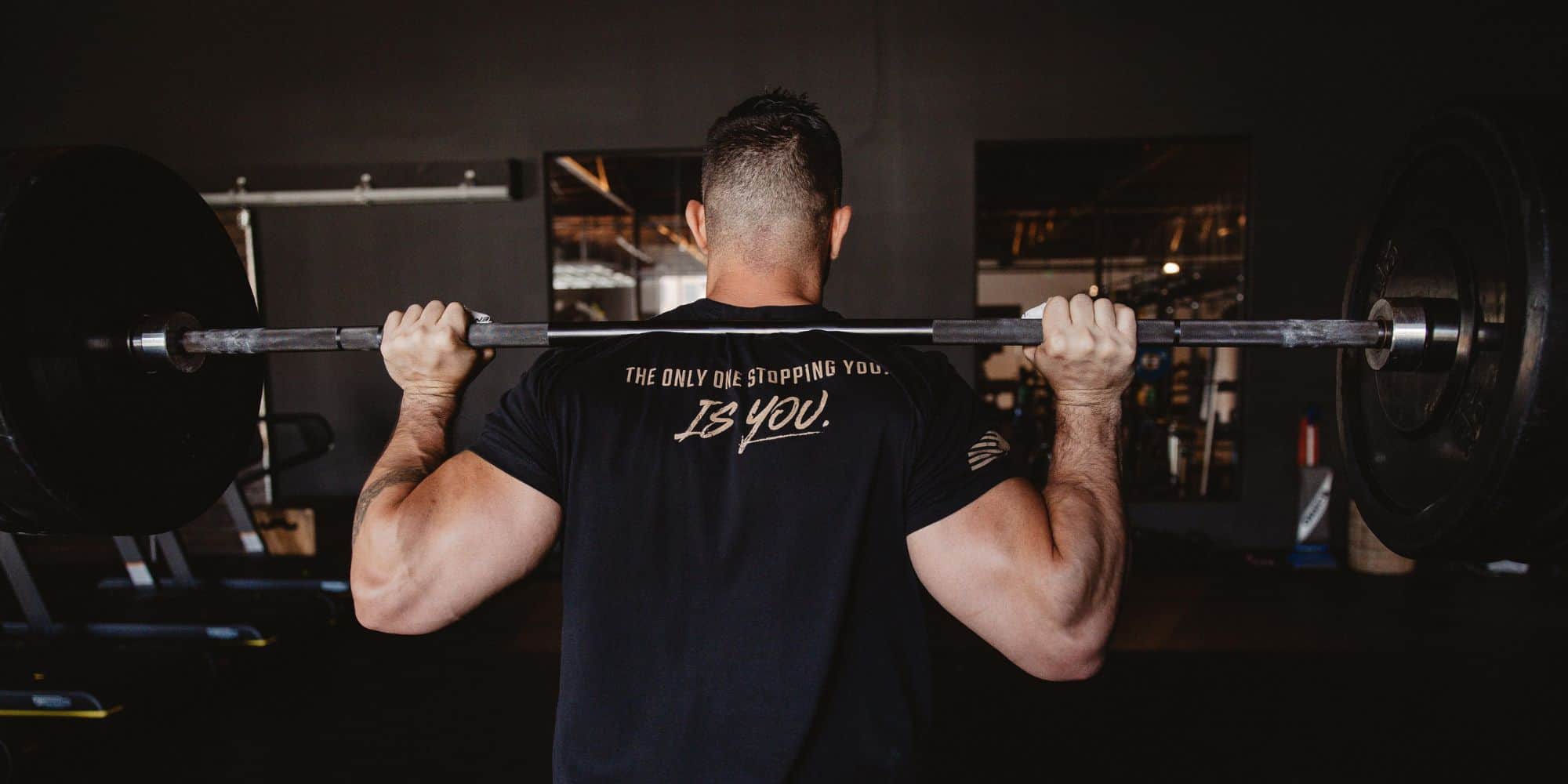 mens graphic t-shirts man wearing a motivational black t-shirt weightlifting 